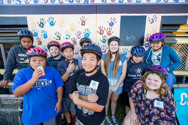 Bike campers with helmets smiling